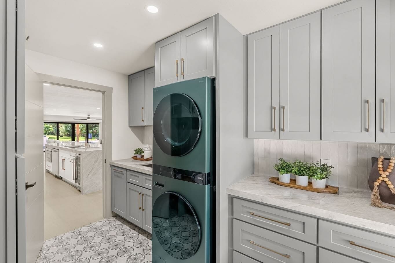 Laundry room with custom cabinetry and marble countertops